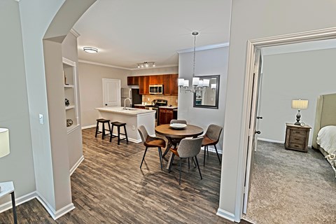 A kitchen with a dining table and chairs.