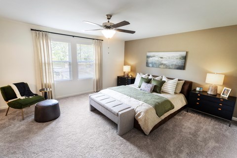 a bedroom with a bed and a ceiling fan