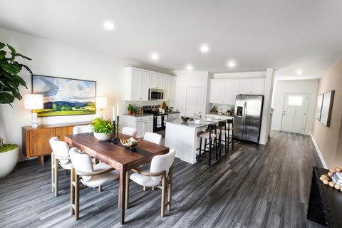 an open kitchen and dining room with a table and chairs
