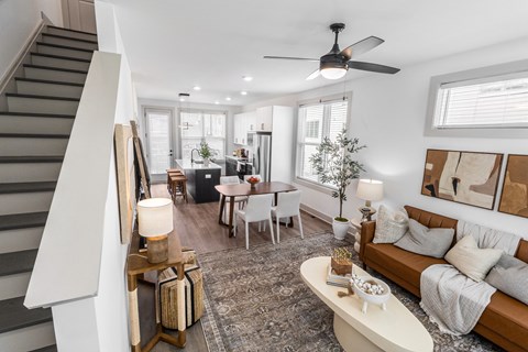 a living room with a couch and a ceiling fan
