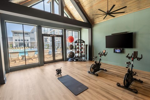 a home gym with a pool and sliding glass doors