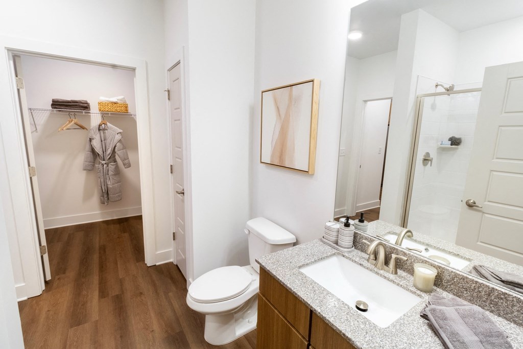 a bathroom with a shower toilet and sink and a mirror