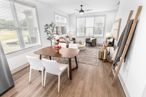 a living room and dining room with a table and chairs