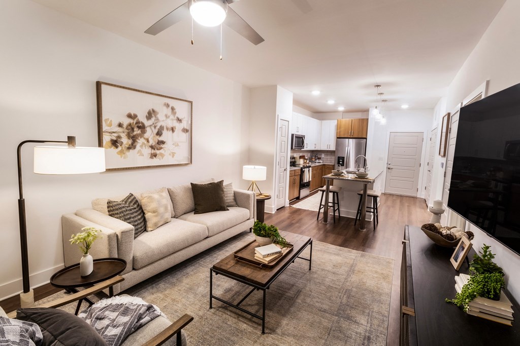 a living room and kitchen with a couch and a table