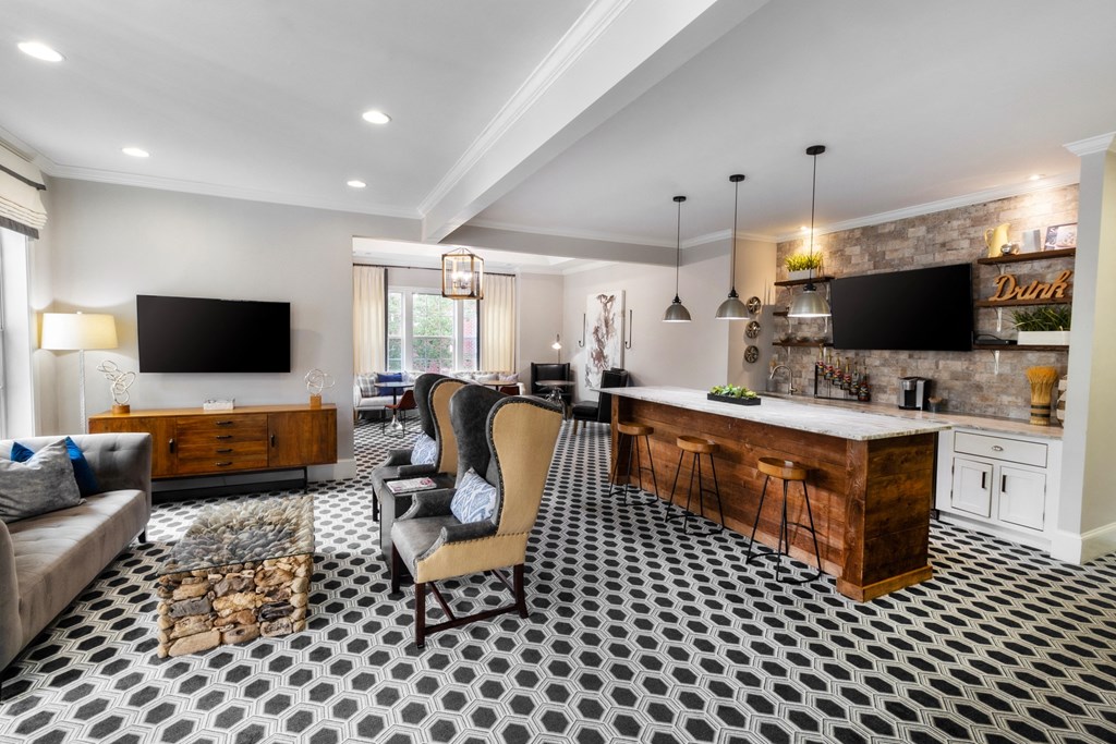 a living room with a kitchen and a television at The Pointe at Suwanee Station, Georgia