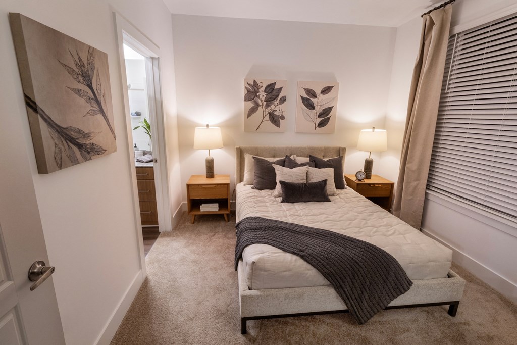 a bedroom with a large bed and a door to a bathroom