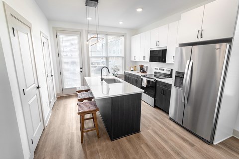 a kitchen with stainless steel appliances and a white counter top