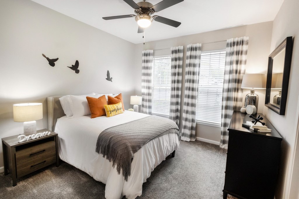 a bedroom with a bed and a ceiling fan at The Pointe at Suwanee Station, Suwanee, Georgia