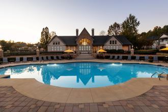 a swimming pool with a house in the background