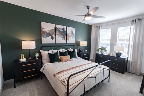 a bedroom with a bed and a ceiling fan