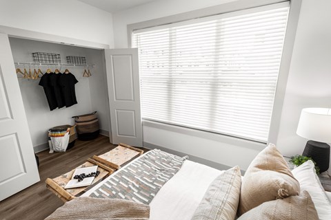 a bedroom with a bed and a large window