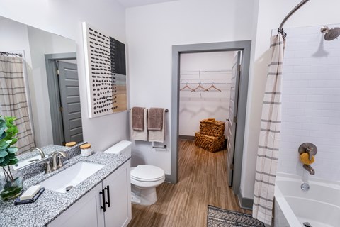 a bathroom with a shower and a sink and a toilet