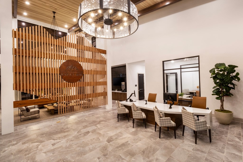 the lobby of a hotel with a table and chairs