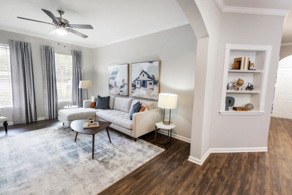 a living room with a couch and a ceiling fan at The Pointe at Suwanee Station, Georgia, 30024