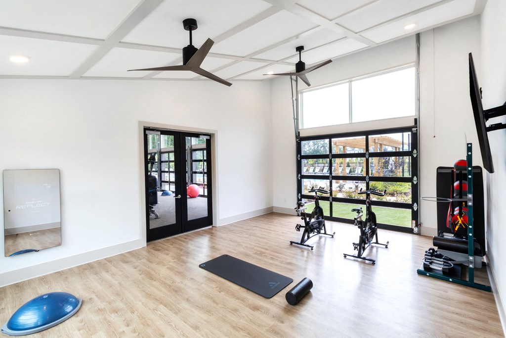 a workout room with yoga equipment and a large window