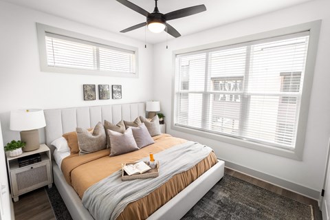 a bedroom with a large bed and a ceiling fan