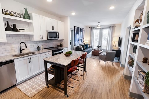 an open kitchen and living room with a table and chairs
