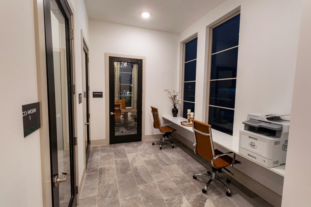 a home office with a desk and a printer