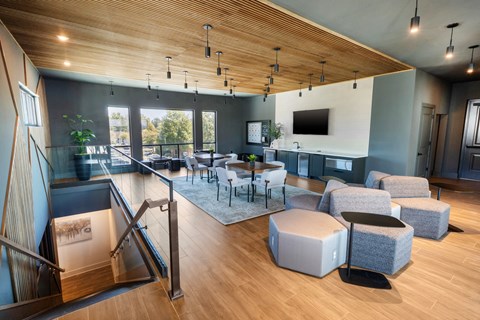 a living room with couches and chairs and a table and a tv