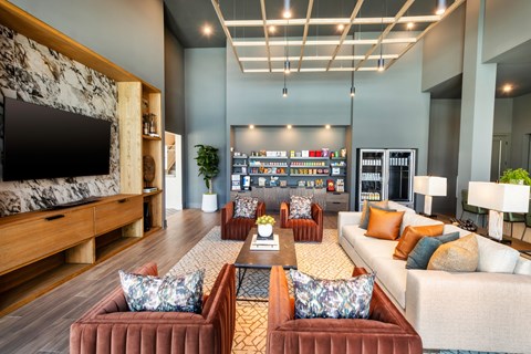 a living room with couches and chairs and a television