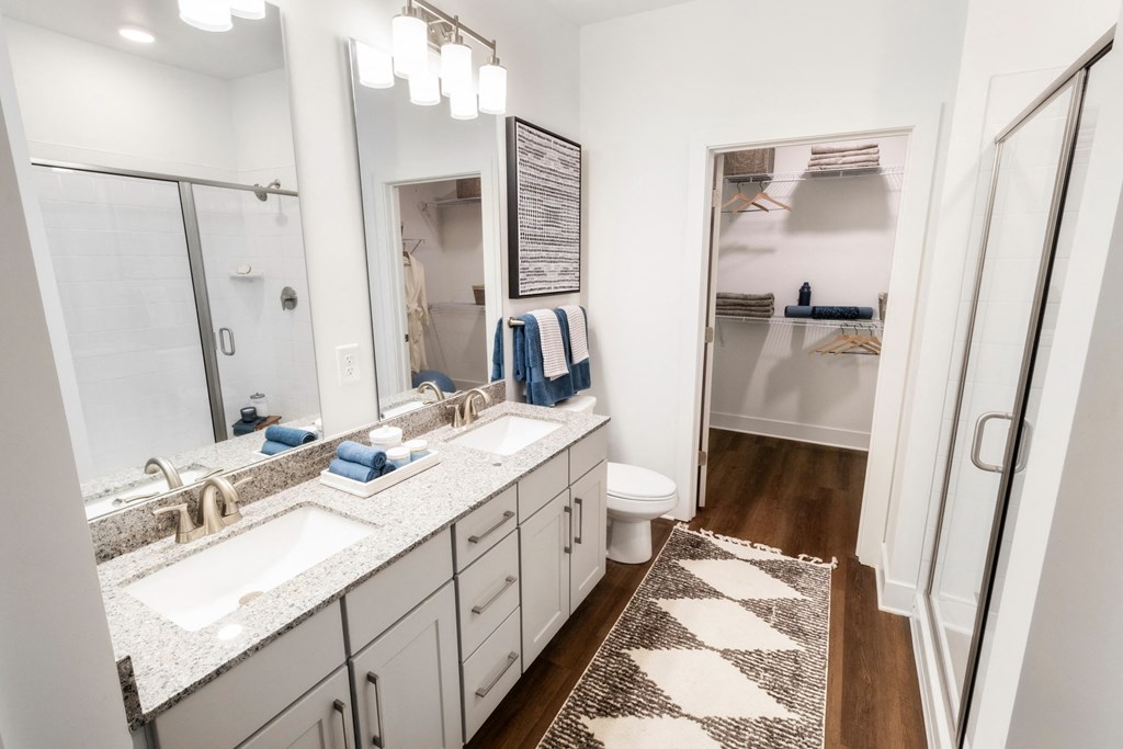 a bathroom with two sinks and a shower and a mirror
