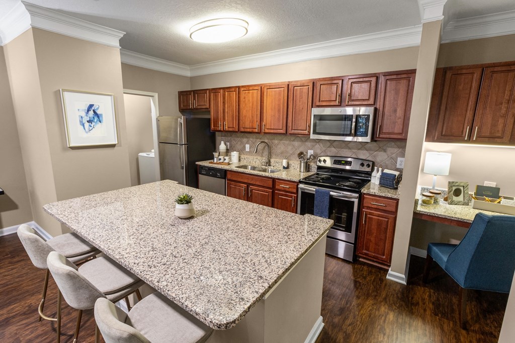 full kitchen with granite countertops and stainless steel appliances at the preserve at greatstone at The Reserve at Sugarloaf Apartments, Georgia, 30097