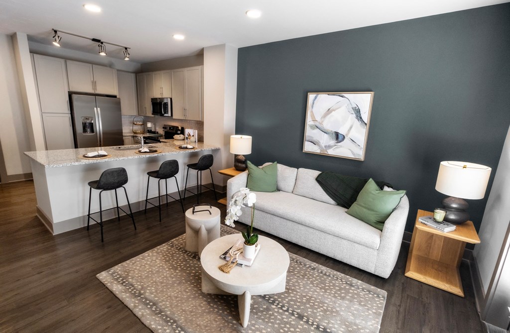 a living room and kitchen with a couch and a table