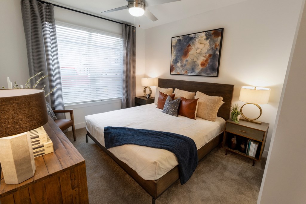 a bedroom with a large bed and a window