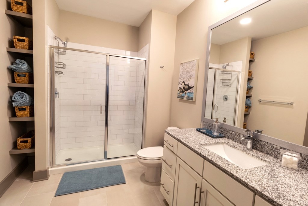 a bathroom with a shower and a sink and a toilet