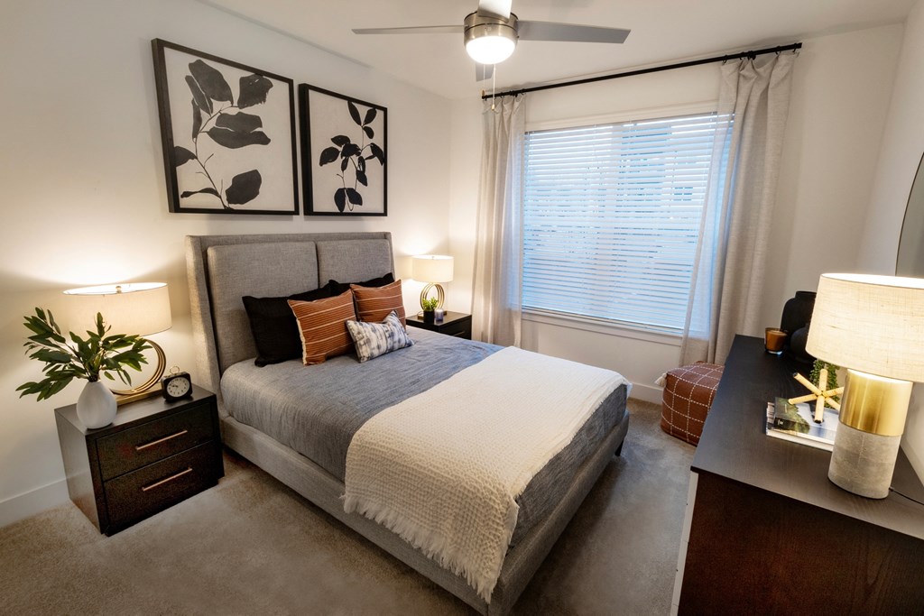 an empty bedroom with a bed and a window