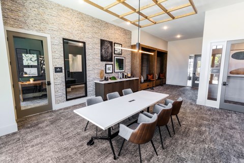 a conference room with a white table and chairs