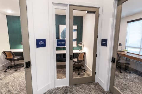 a row of mirrors in a room with a desk and a chair