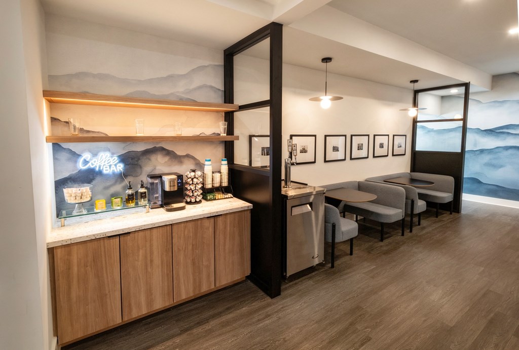 a tasting room with a bar and a mountain mural on the wall