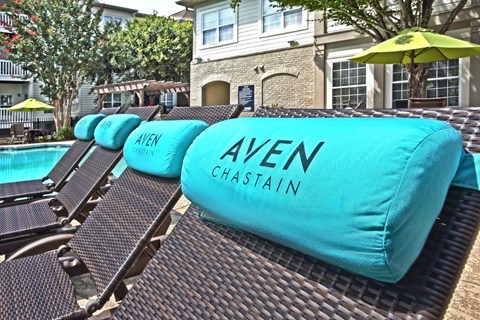 A row of Ayen Chain lounge chairs are arranged on a patio.