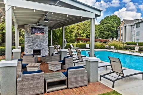 covered pavilion with tv and fire pit next to pooln at Lullwater at Calumet, Georgia