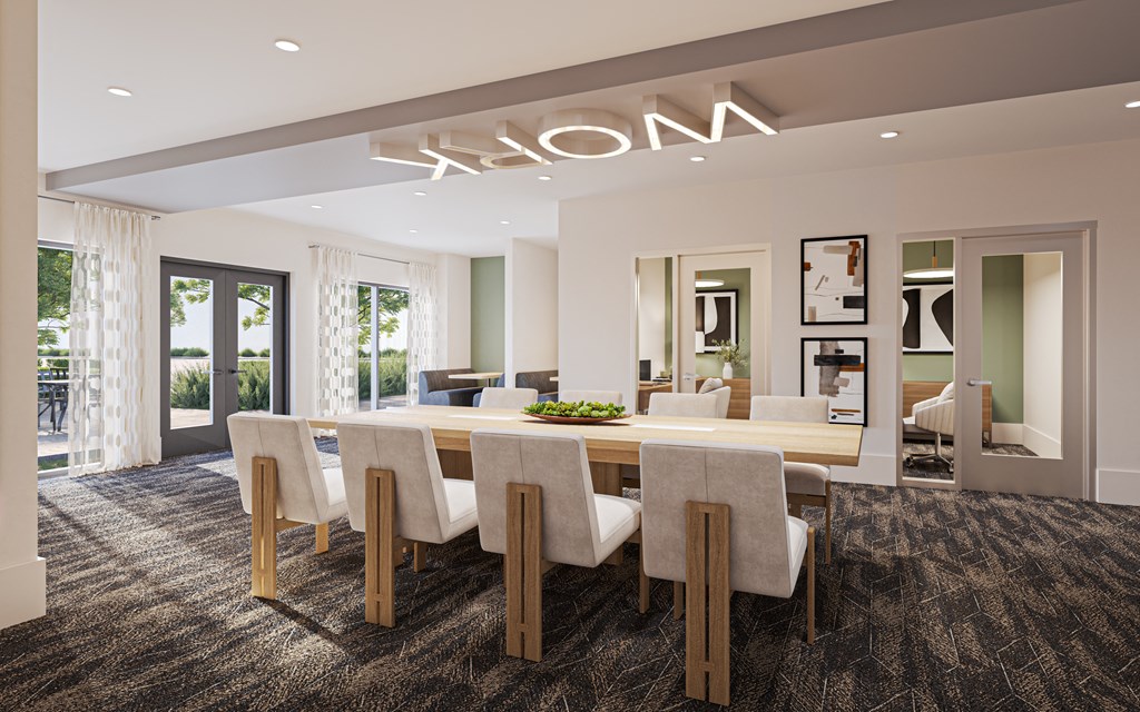 A conference room with a long table and chairs.