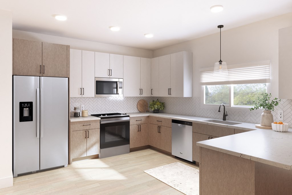 A modern kitchen with a refrigerator, microwave, oven, sink, and dishwasher.