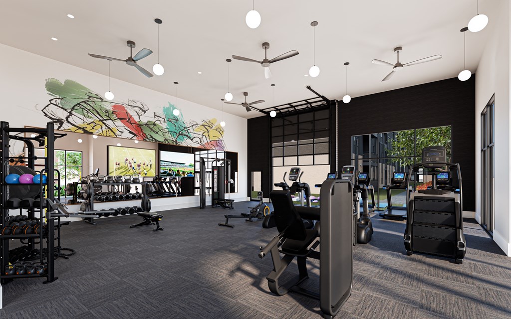 A gym with a variety of equipment including treadmills, weights, and exercise machines.