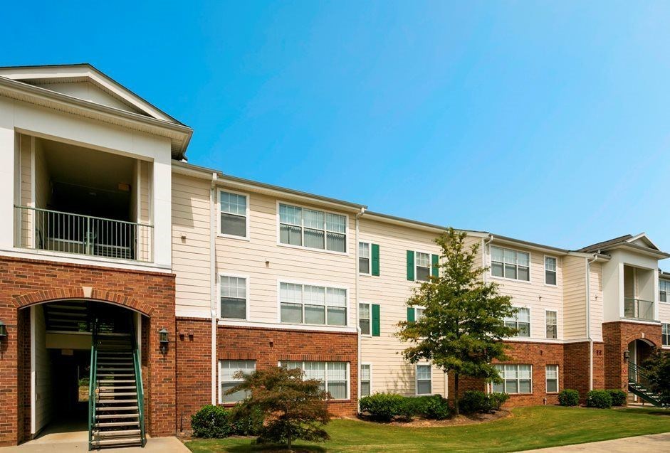 A large apartment building with a green lawn in front. at The Dawson Cartersville in Cartersville, GA 30191