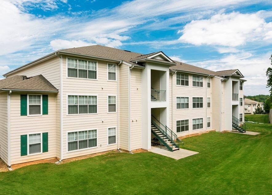 A large apartment building with a green lawn in front. at The Dawson Cartersville in Cartersville, GA 30191