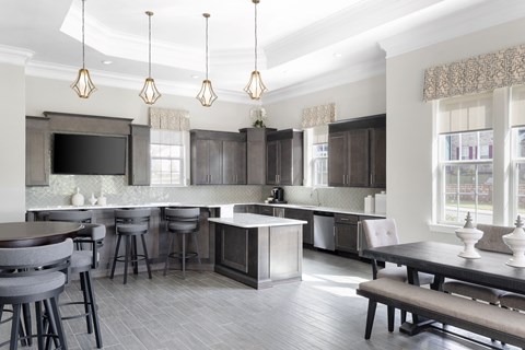 a large kitchen with a dining area and a table with chairs