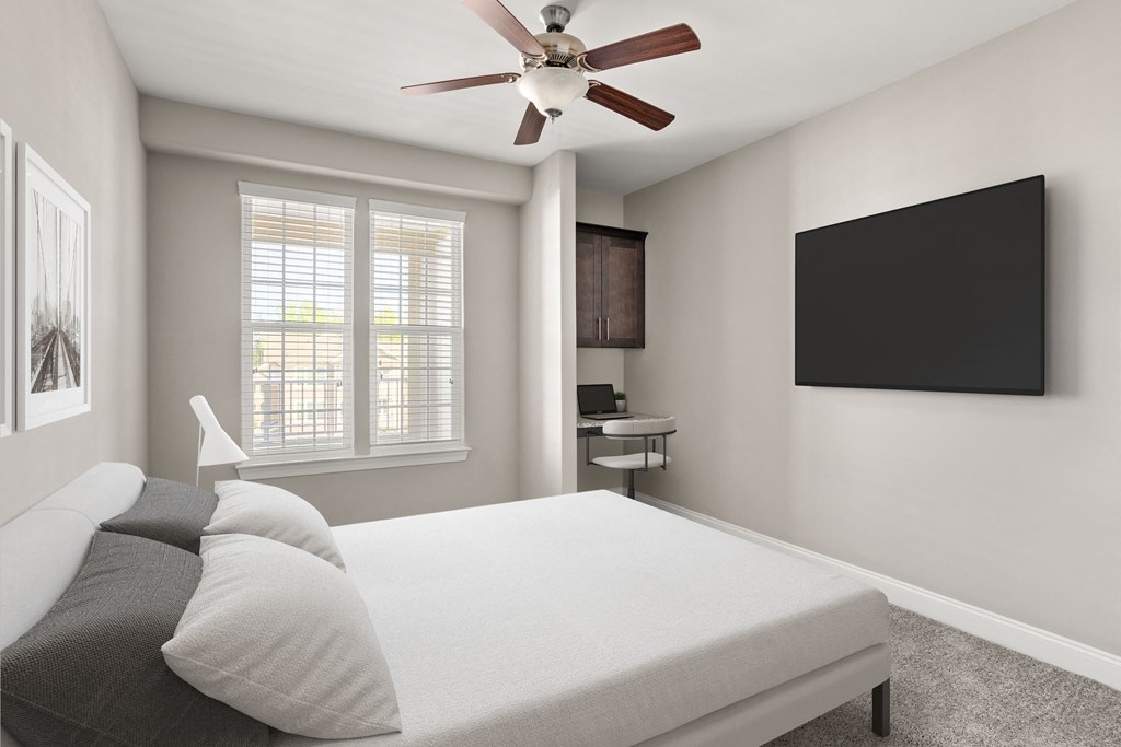 a bedroom with a bed and a ceiling fan