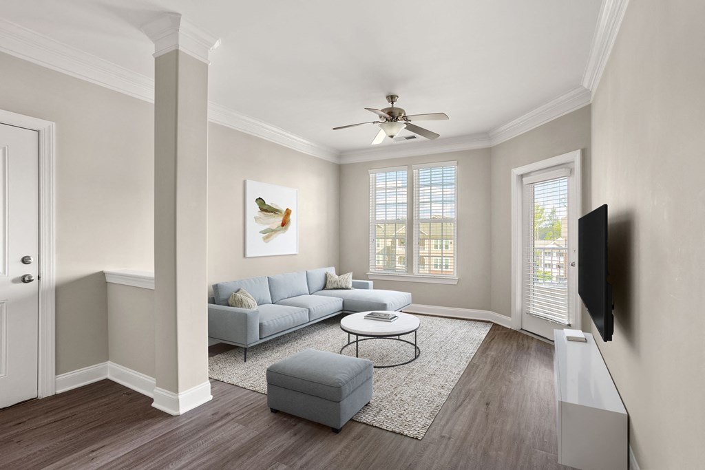 a living room with a couch coffee table and a ceiling fan