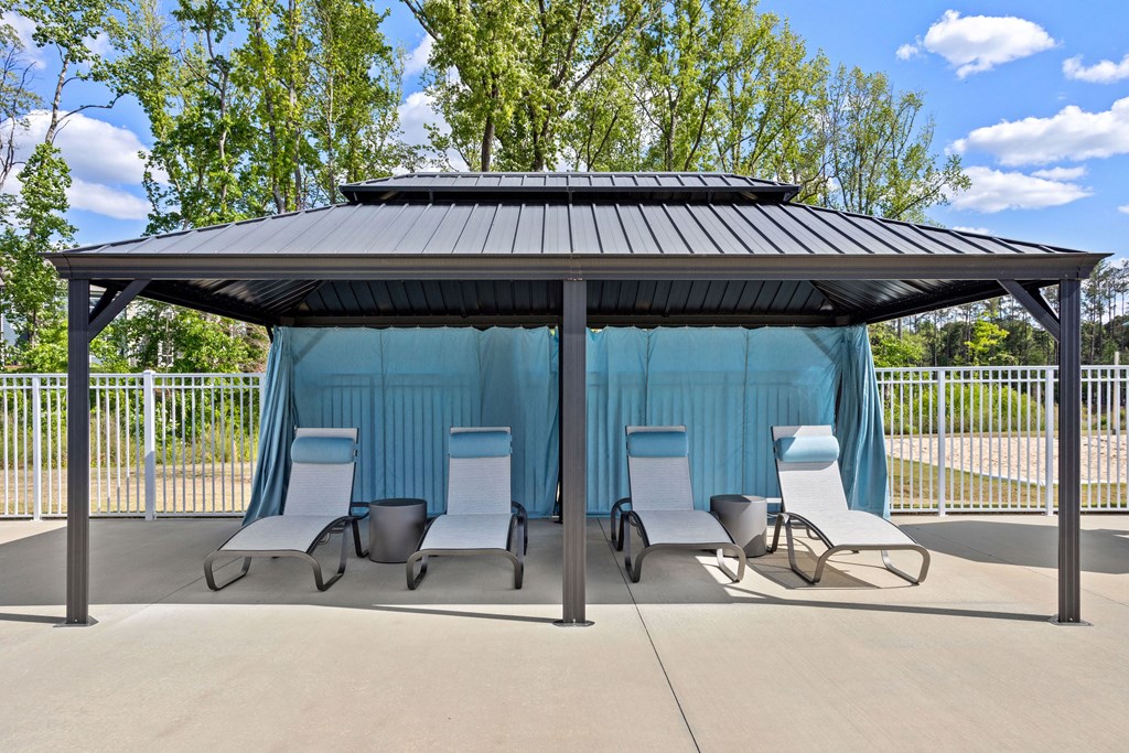 a gazebo with chairs under it