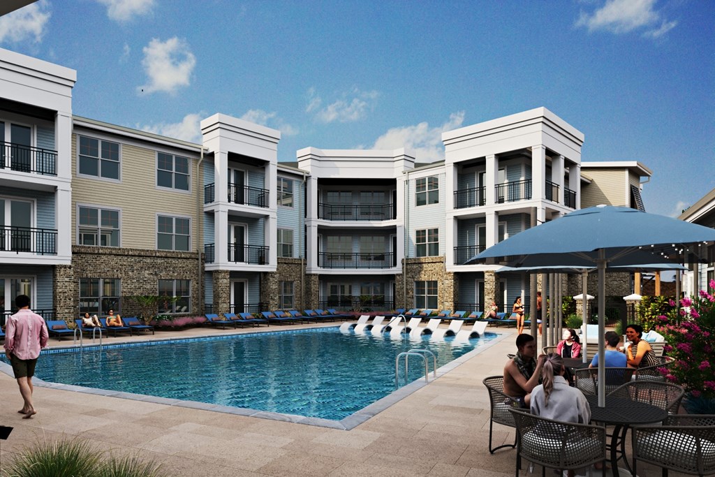 people sitting around a swimming pool in front of an apartment building