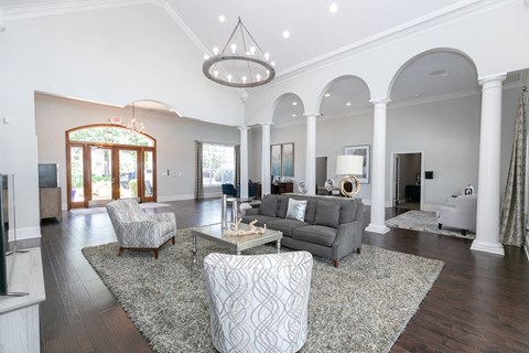 a living room with a couch and chairs and a table