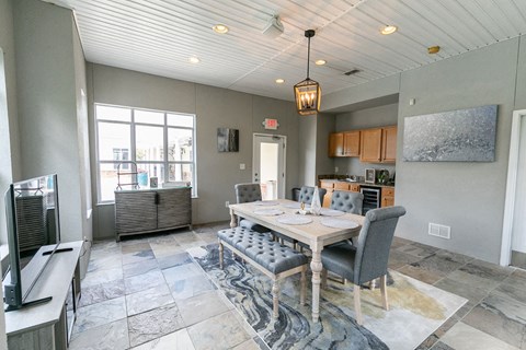 a dining room with a table and chairs and a kitchen