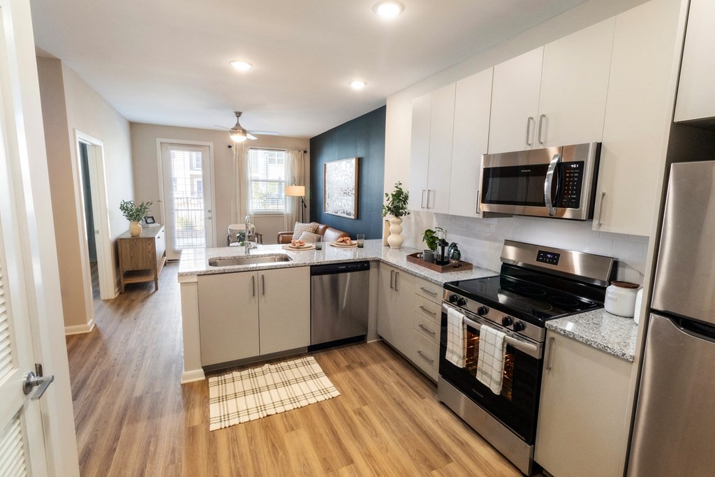 a kitchen with stainless steel appliances and white cabinets
