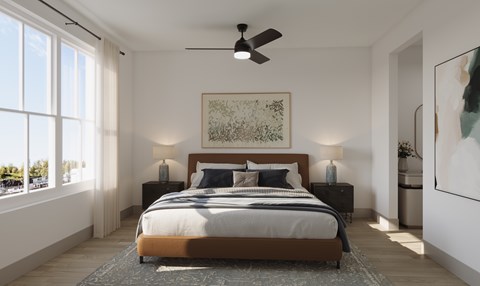 A bedroom with a large bed and a ceiling fan.