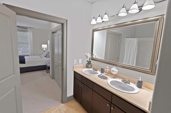 a bathroom with two sinks and a large mirror - Photo Gallery 21